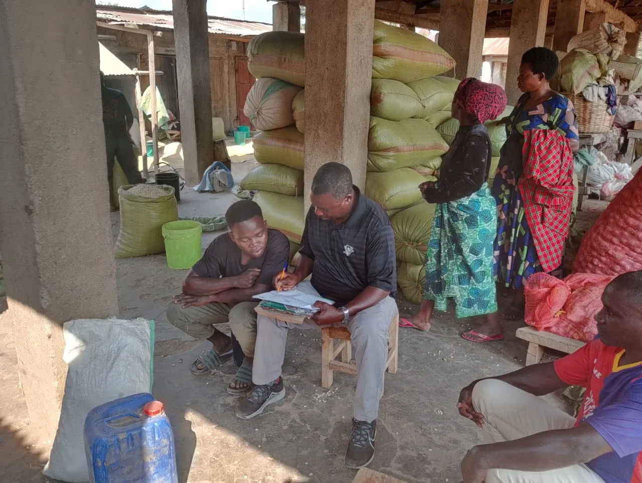 Youth traders at a grain store being mobilized for the Kasumulu CBTA